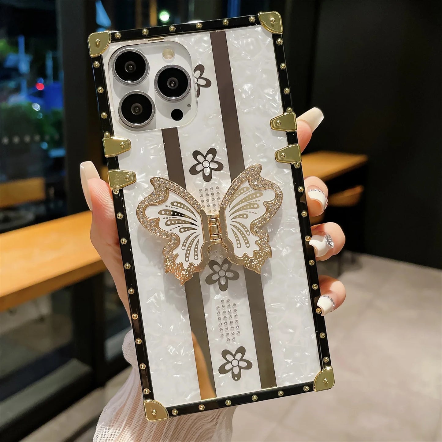 Elegant butterfly diamond iPhone case with sparkling crystal accents, designed to protect your phone while adding a touch of glamour.