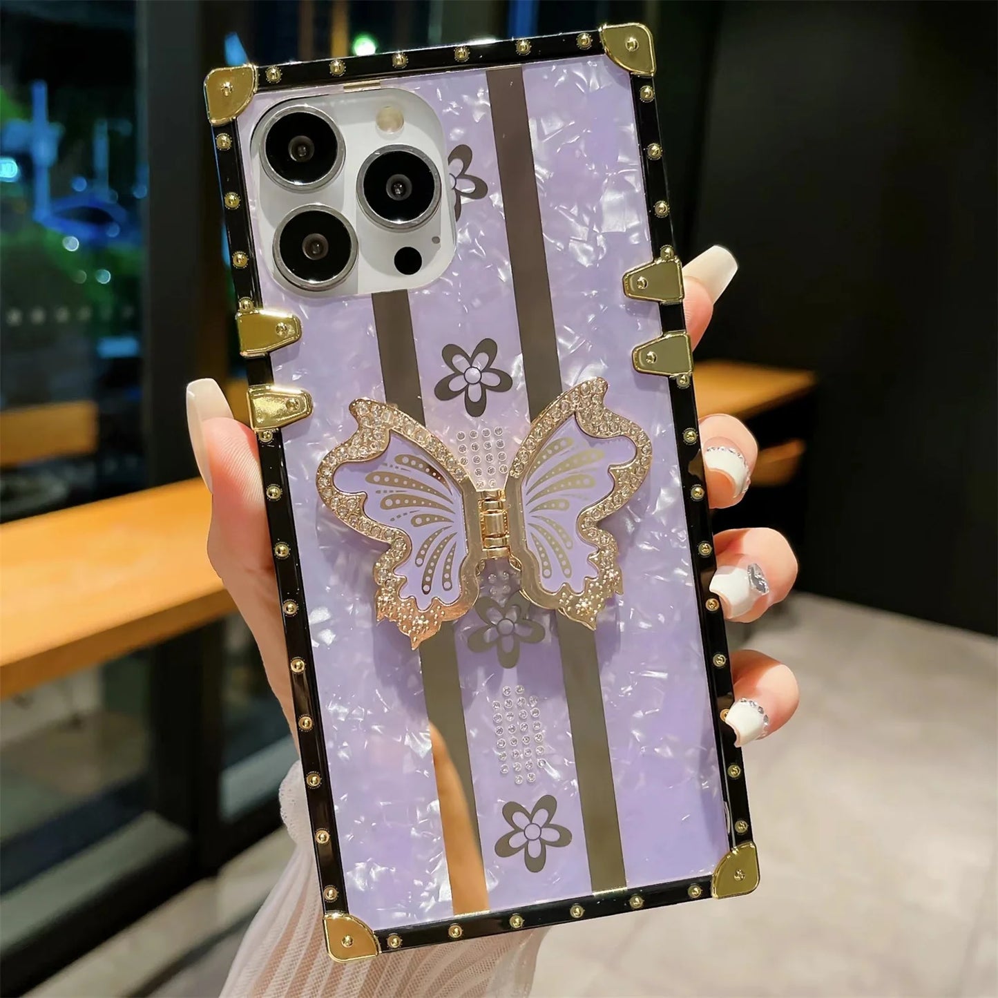 Elegant butterfly diamond iPhone case with sparkling crystal accents, designed to protect your phone while adding a touch of glamour.